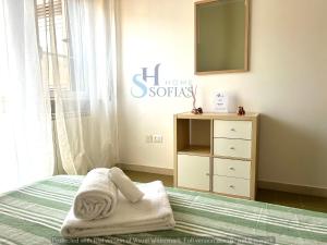 a bedroom with a bed with a mirror and a dresser at Sofia's Home 2 in Terracina