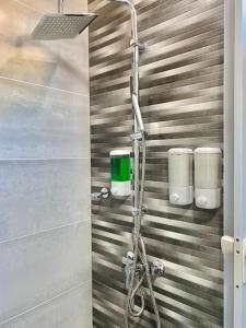 La salle de bains est pourvue d'une douche et d'une porte en verre. dans l'établissement Cozy City Center Condo Full AC, à Saint-Domingue