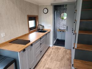 a kitchen with a sink and a counter top at The Tiny House in Bovey Tracey