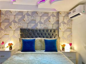 1 dormitorio con 1 cama con almohadas azules en Gorgeous 3 Bdrm Apartment, en Los Prados