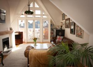 a living room with a couch and a fireplace at Britannia House in Lymington