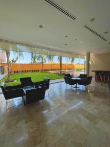 a large room with chairs and tables and a large window at Altavista Hotel in Reynosa