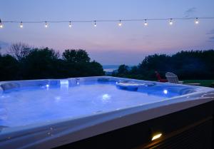 a jacuzzi tub in a backyard at night at Hilltop Retreat & Spa in Tully