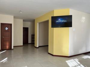 a lobby with a sign on a yellow wall at Family house/casa de Familia 3 bedroom 3 bath in Baños