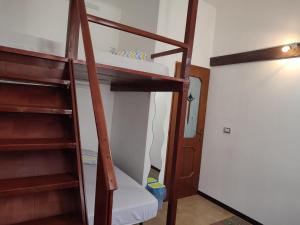 a room with two bunk beds with a ladder at Alba Private Room in Milan