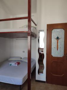 a bedroom with two bunk beds and a cross on the door at Alba Private Room in Milan