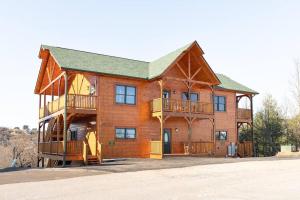 a large wooden house with balconies on it at Cabin 6BR/8BA Smokies Views in Gatlinburg