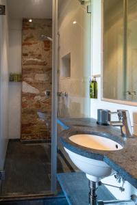 a bathroom with a sink and a shower at Olimagio Farm Stay with animals and 25m pool, beach at cycling distance in Pietrasanta
