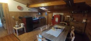 een keuken met een eettafel en een rode koelkast bij A&J House in Canale San Bovo