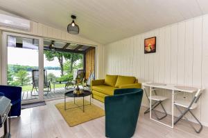 a living room with a yellow couch and a table at Volunge house in Doškonys