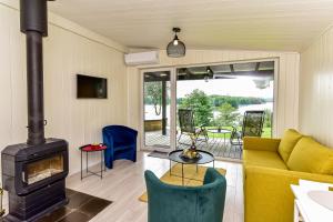 a living room with a couch and a fireplace at Volunge house in Doškonys