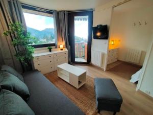 a living room with a couch and a large window at Appartement Avoriaz, 2 pièces, 4 personnes - FR-1-633-73 in Morzine