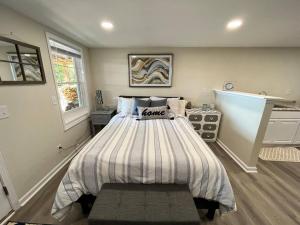 a bedroom with a bed with a striped comforter at Lakeside serenity in Newnan in Newnan