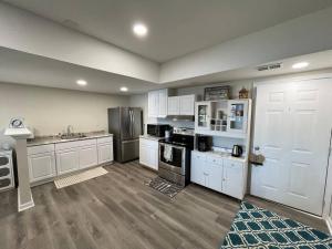 a large kitchen with white cabinets and appliances at Lakeside serenity in Newnan in Newnan