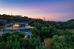 a house on a hill with the sunset in the background at Karel house in Karés