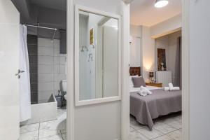a room with a bed and a bathroom with a mirror at Karel house in Karés +28 photos