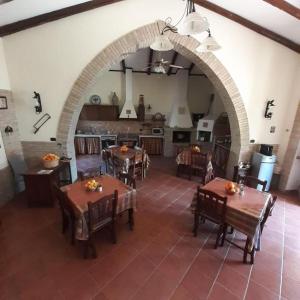 a large dining room with tables and a kitchen at B&B Villa Rosalia in Barrafranca