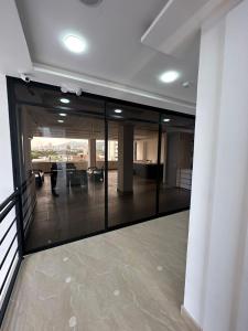 a lobby with glass doors and a room with a table at Mar Apartamentos in Bucaramanga