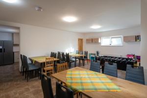 a dining room with wooden tables and chairs at Rezidencia Podhájska in Podhájska