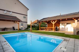 a swimming pool in the backyard of a house at Rezidencia Podhájska in Podhájska