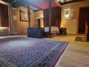 una camera con un letto e un tappeto in una stanza di 2 Suites dans demeure authentique du XVÈME 
