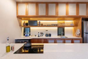 a kitchen with wooden cabinets and a counter top at Departamento de lujo en mérida (Planta baja). in Mérida