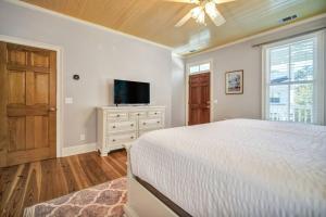 a bedroom with a bed and a flat screen tv at Bluffton Village Home-4BR Heart of Old Town Luxury in Bluffton