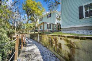a house with a fence in front of it at Bluffton Village Home-4BR Heart of Old Town Luxury in Bluffton