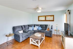 a living room with a couch and a tv at Private Beach and Dock Waterfront Panacea Retreat! in Panacea