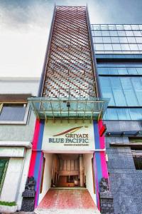 a large building with a blue refuge sign on it at Javein Griyadi Hotel in Jakarta