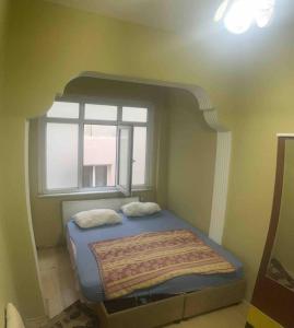 a bed in a room with a window at Fatih Econo Apart in Istanbul