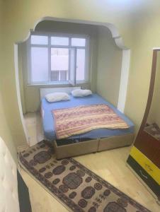 a bed sitting in a room with a window at Fatih Econo Apart in Istanbul