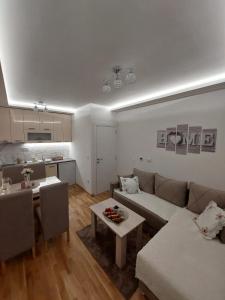 uma sala de estar com um sofá e uma mesa em Apartman Stevanovic Zlatibor em Zlatibor