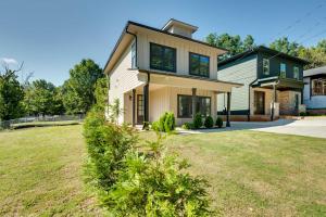 a house with a grass yard in front of it at Luxury Smart Home 2 Miles to Downtown Atlanta! in Atlanta