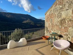 a balcony with a white chair and a table at Casa Pero Soares in Guarda