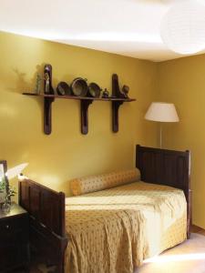 a bedroom with a bed and shelves on the wall at Casa Pero Soares in Guarda