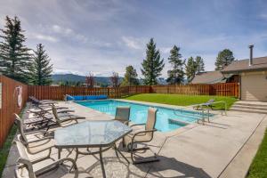 a patio with chairs and a table and a pool at Cozy Condo Near Golf, 7 Mi to Big Sky Resort! in Gallatin Gateway
