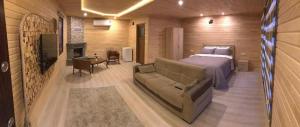 博德魯姆的住宿－Trabzon Karadeniz Uzungol，一间卧室配有一张床、一张沙发和一个壁炉