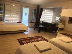 a hotel room with two beds and a living room at Trabzon Karadeniz Uzungol in Bodrum City