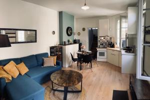 sala de estar con sofá azul y mesa en L'inattendue, en Pierrefonds