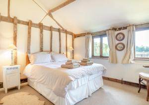 a bedroom with a bed with towels on it at Shepherds Watch in Saint James