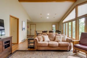 a living room with a couch and a tv at Lakefront Home with Beach, Deck and Fire Pit! in Alexandria