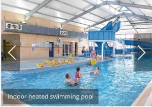 a group of children playing in a swimming pool at Quince in Ferndown