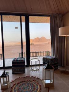 a living room with a view of the desert at Rashed Luxury Camp in Wadi Rum