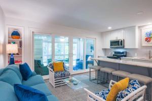 a living room with a blue couch and a kitchen at Sapphire Seascape in Kiawah Island