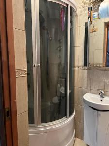 a glass shower in a bathroom with a sink at Vabaduse Guesthouse in Narva-Jõesuu +17 photos