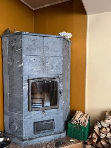 a stone fireplace in the corner of a room at Vabaduse Guesthouse in Narva-Jõesuu