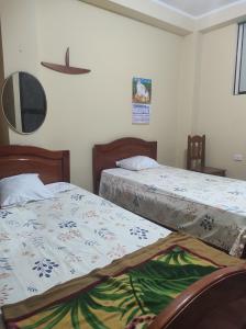 two beds sitting next to each other in a bedroom at DonnaSabi in Tingo María