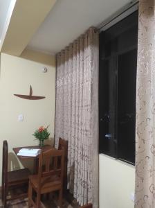 a dining room with a table and a window at DonnaSabi in Tingo María