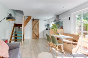 a living room with a table and chairs and a kitchen at The Forester Schoorl in Schoorl
